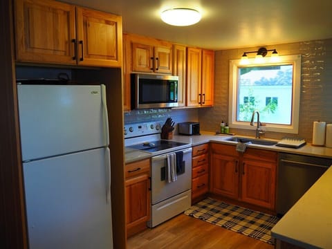 KITCHEN:  The cottage has a newly-remodeled kitchen with all modern appliances, including a dishwasher and a little coffee bar.  There is also a good supply of cooking and dining utensils provided.