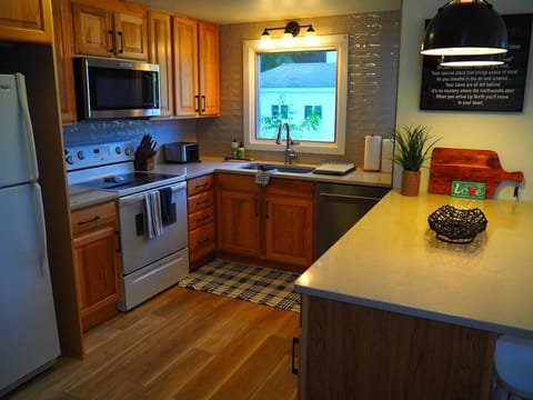 KITCHEN:  The cottage has a newly-remodeled kitchen with all modern appliances, including a dishwasher and a little coffee bar.  There is also a good supply of cooking and dining utensils provided.