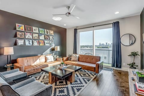 Open living room/kitchen area. Fully stocked kitchen with everything you could need. Smart TV in the living room. The two couches turn into futons. Private balcony right off the living room with a great view of downtown Nashville.