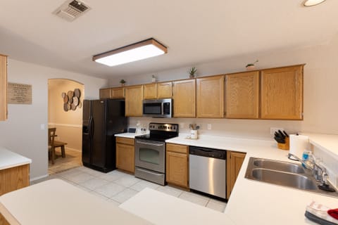 Spacious kitchen with full appliances and essentials provided.