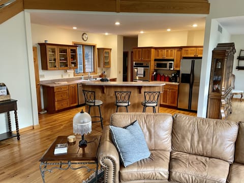 Bar seating for 3 open to both kitchen and living area 