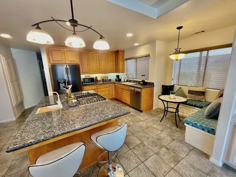 Kitchen with large island and all new luxurious stainless steel appliances. 