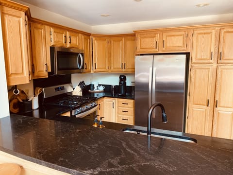 Updated kitchen with stone counter tops, wine fridge & Nespresso coffee maker. 
