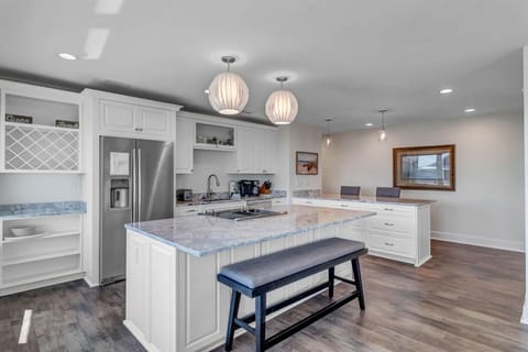- Whip up meals in this open kitchen with granite counters, stainless appliances, and wine storage
- Double pendant lights and seating options add both style and function
- Perfect setup for cooking, entertaining, or casual breakfasts