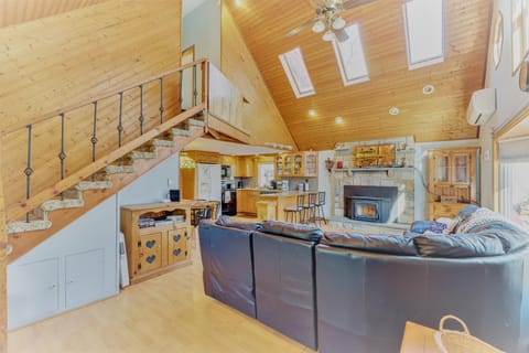View upon entering the chalet - a 2 story living room with fire place. 