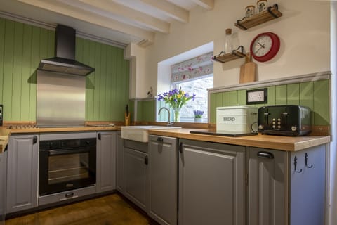 Ground floor: Delightful cottage kitchen with Belfast sink overlooking the patio area