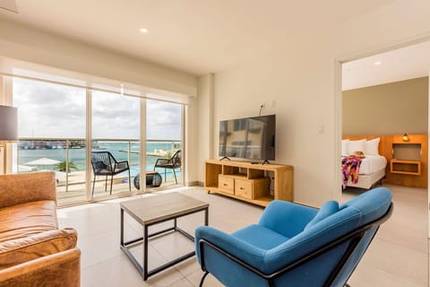 Relax in your open-concept living space where modern comfort meets stunning waterfront views, perfect for unwinding after a day of island adventures.