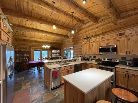 Large kitchen. Electric stovetop. Large fridge. Island. Buffet and dining table