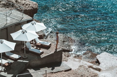 On the beach, black sand, sun loungers, beach umbrellas