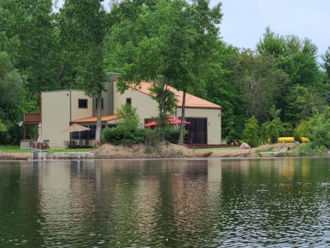 Nestled on a private community lake with 200'  of lakefront on 4 wooded acres