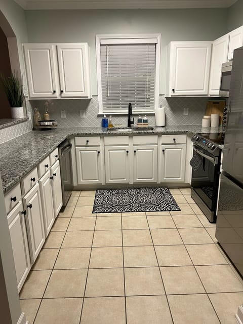 Fully stocked kitchen from dinnerware, glassware, pots, pans