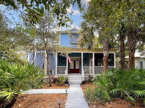 A charming Southern-style retreat nestled in greenery with patriotic flair.