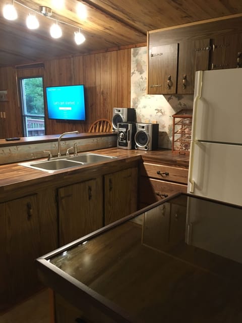 Kitchen island in foreground, wall mounted flat screen Roku TV