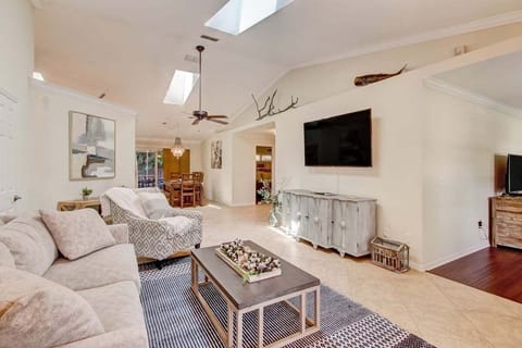 Living Room: comfortable couch, 2x accent chairs, smart TV - Perfect for lounging with family.