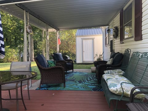 Covered patio, gas grill, table with umbrella