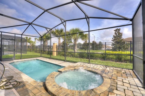 Screened private pool and relaxing spa with seating area and water view
