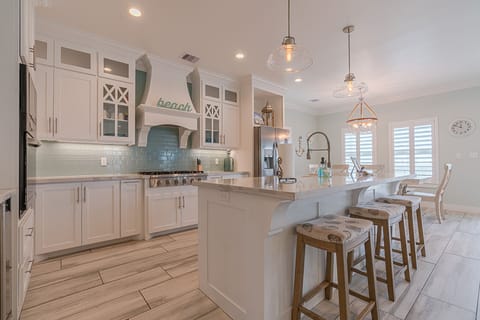 Fully equipped gourmet kitchen with upgraded appliances, dishwasher, and all cookware needed for group meals.