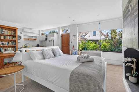 Spacious and inviting queen bedroom featuring a comfortable bed, soft furnishings, and a bright, relaxing atmosphere—perfect for a restful stay.