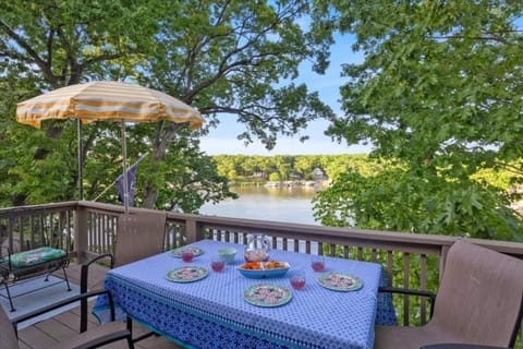 Dining table off the upper level deck with beautiful surrounding trees.