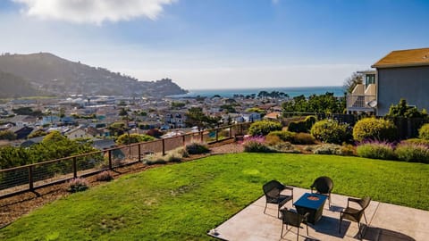 Spacious outdoor seating with table, chairs, and a beautiful ocean view