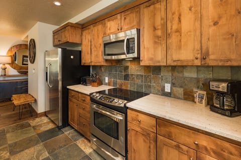 Fully stocked kitchen with cookware and dishware.
