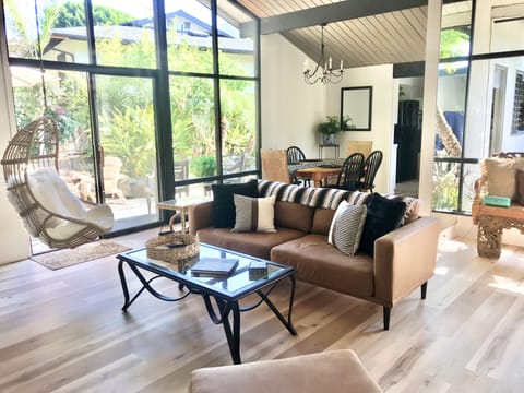 Livingroom with fireplace, TV and hanging chair.