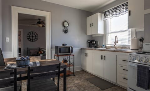 The dining table and chairs are located in the eat-in kitchen.