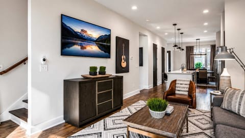 Modern living area with abundant natural light and an open flow into the kitchen, perfect for relaxing and gathering together.