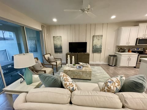 Family room is open to the kitchen area and overlooks the pool area.