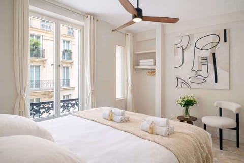 The spacious bedroom full of light with ceiling fan and storage for your belongings.