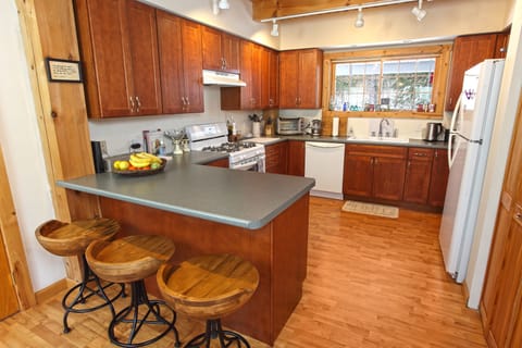 Kitchen filled with all the essential spices, air fryer, milk frother, & coffee.