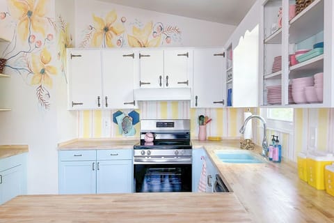 Cheerful kitchen is stocked with everything you need to make delicious meals.