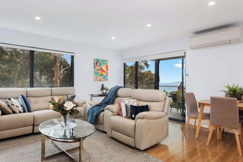 Upstairs lounge room with electric recliners and smart TV