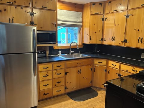 Knotty pine kitchen stocked with new appliances to meet all your cooking needs. 