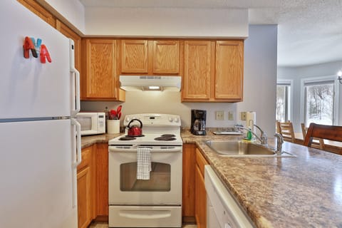 Bright modern Kitchen, open floor plan brings all your social activities together.  Stocked with what you need for home cooked meals and entertaining guests.