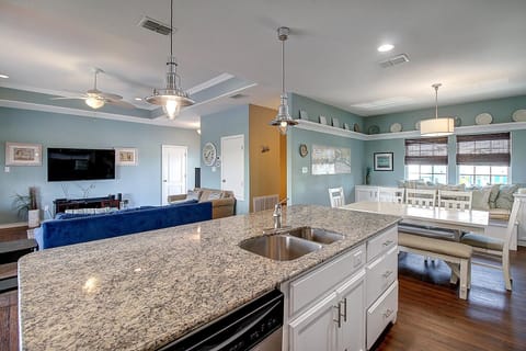 Kitchen island overlooking dining and living areas. - Island breakfast bar for casual dining
