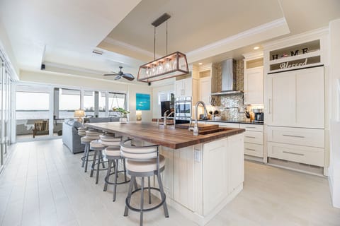 A fully equipped chef's kitchen and bar seating for an aperitif with guests