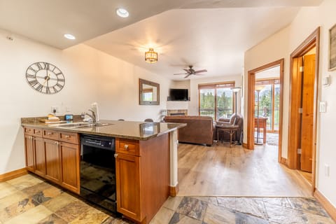 Your spacious open-plan kitchen and living area welcomes you with warm wood accents and granite countertops, perfect for relaxing.