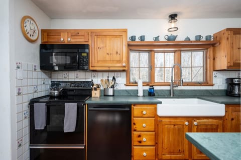 Enjoy the rustic charm of our kitchen with our stylish VT soapstone counters and wooden cabinets, stocked with kitchen essentials.