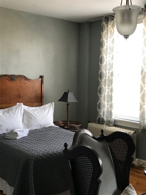 Antique full size bed with quality linens.