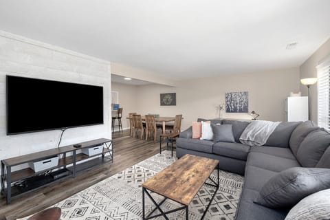 Spacious living room with 70” Smart TV and plenty of seating for movie night.

