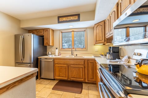 Full-size kitchen with updated stainless steel appliances.