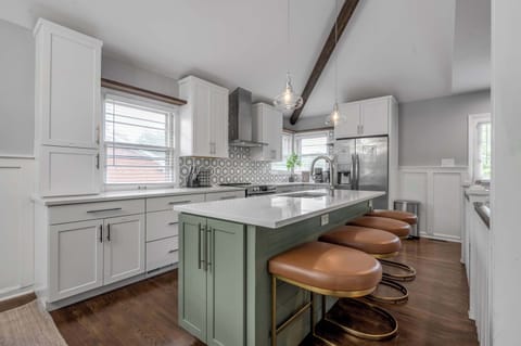 Step into a thoughtfully designed kitchen where an island countertop with four seats invites laughter, flavor, and togetherness in every meal experience.