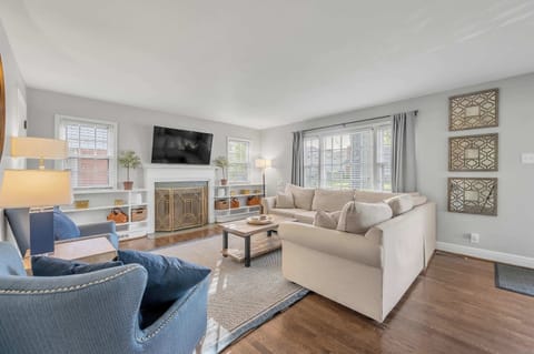 Relax in a spacious, light-filled living room featuring seating for up to 10 guests and a large smart TV. Contemporary décor, comfortable furnishings, and a warm, inviting atmosphere make it the perfect hub for gathering after a day of adventure.