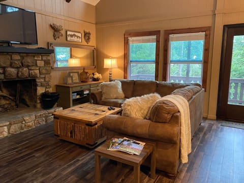 Living Room with fireplace and open to dining and kitchen, balcony access 