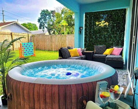Enjoy relaxing in the hot tub with your group, while sipping on a refreshing drink and watching the kids play in the backyard. The speaker for the hot tub is kept in the drawer in the kitchen.  The greenery wall was taken down by Hurricane Milton.