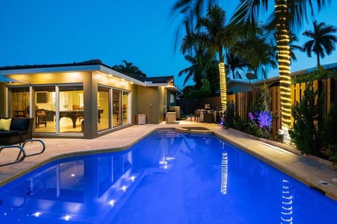 Relax in the private backyard, with amazing day and sunset views with amenities that include a heated saltwater pool & spa with pool floats/toys, outdoor shower with hot/cold water, large umbrella with LED lighting for shade, outdoor fan, BBQ grill, outdoor TV, colorful evening landscape lighting and comfortable lounge/dining seating all surrounded by lush tropical landscaping.