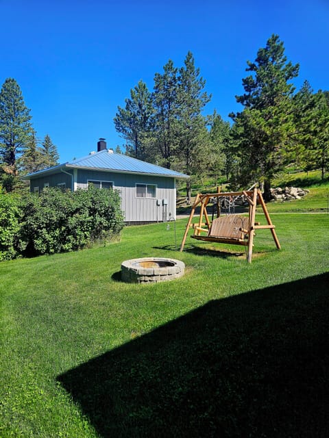 Side yard with firepit and swing.