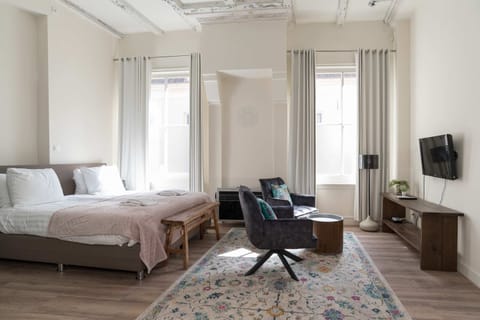 Room view - Bed and seating area with TV