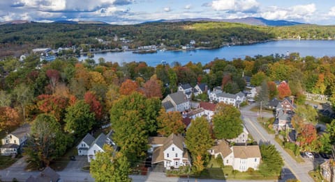 View of house with lake and downtown Meredith in background
